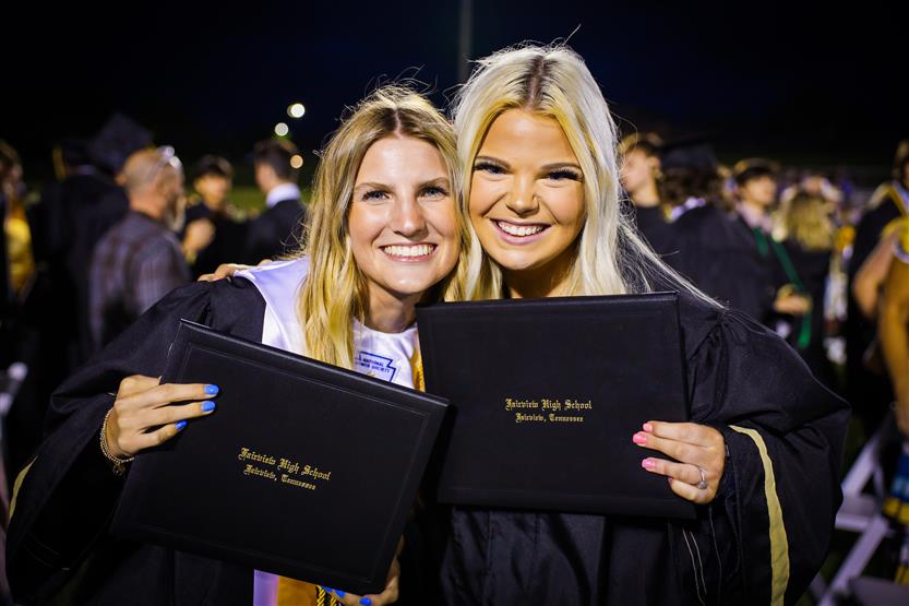 Students graduate on a football field